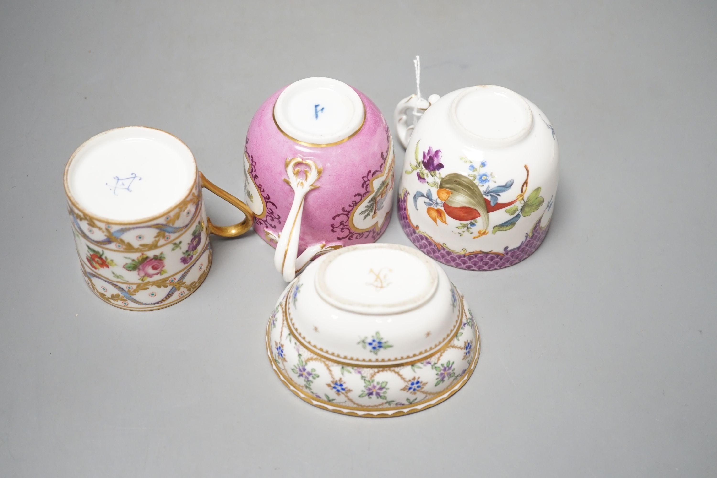 An 18th century Meissen pink ground coffee cup with entwined handle painted on two sides with a figural landscape on a pink ground, a 19th century French box and cover painted with flowers, a German coffee cup with pink